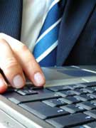 Person's hand on laptop keyboard